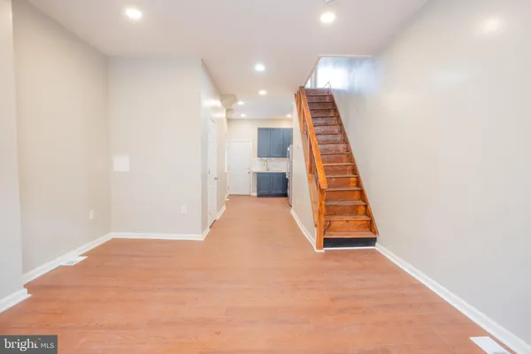 a view of an empty room with wooden floor
