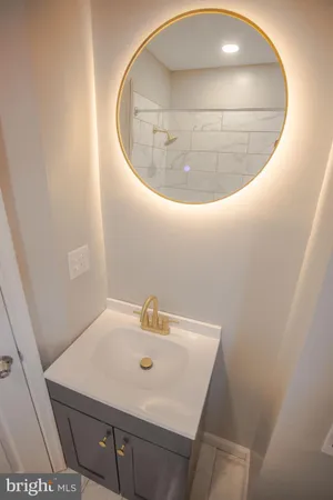 a bathroom with a sink a toilet and a window