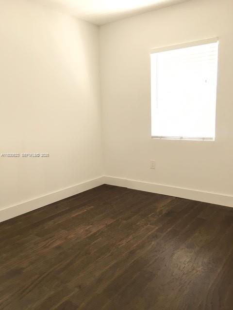 342 Northwest 84th Terrace, Unit 342 Miami, FL 33150 - Photo 6 of 9 an empty room with wooden floor and windows