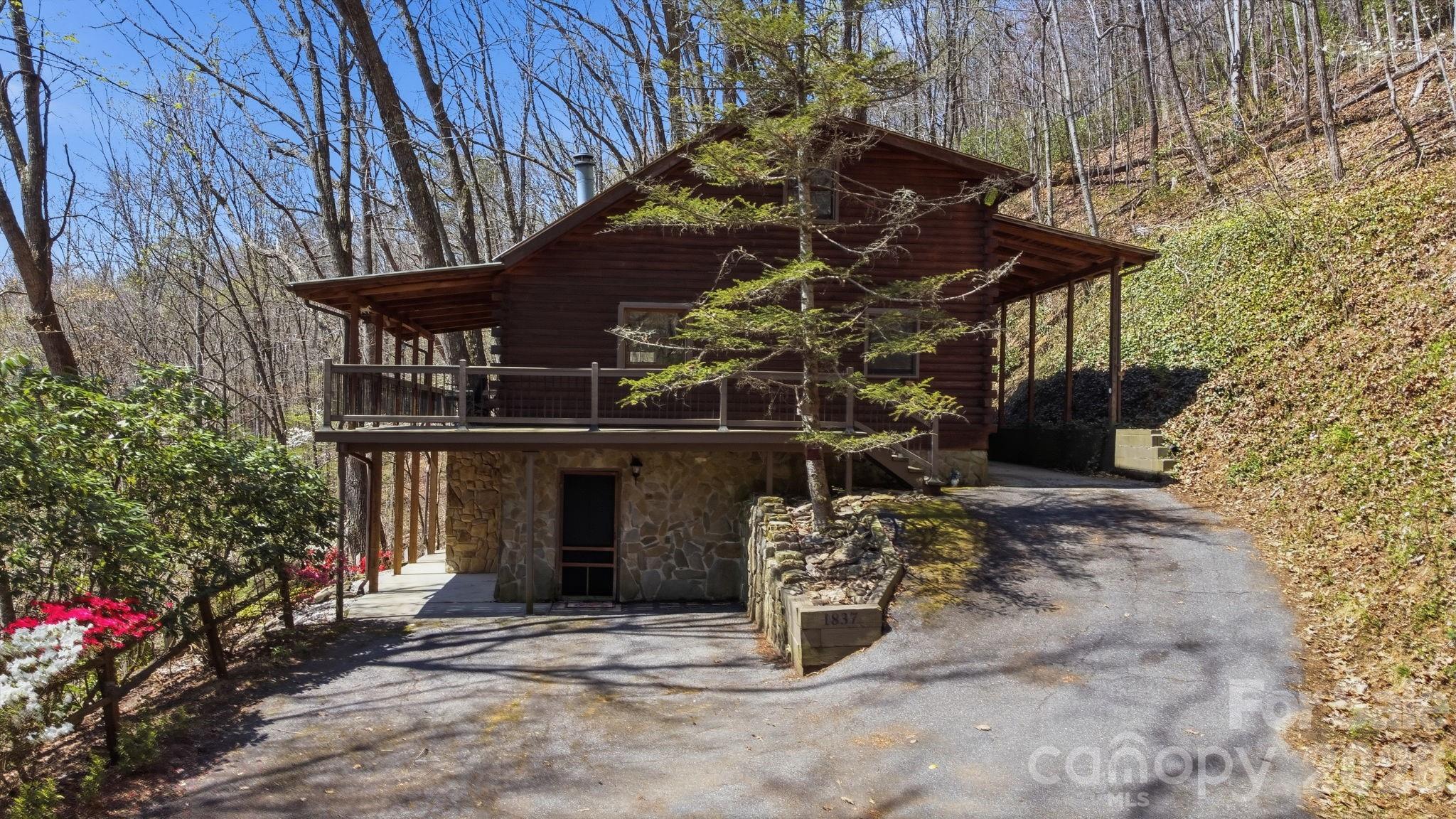 1837 East Alarka Road Bryson City, NC 28713 - Photo 2 of 34 a view of a house with a yard
