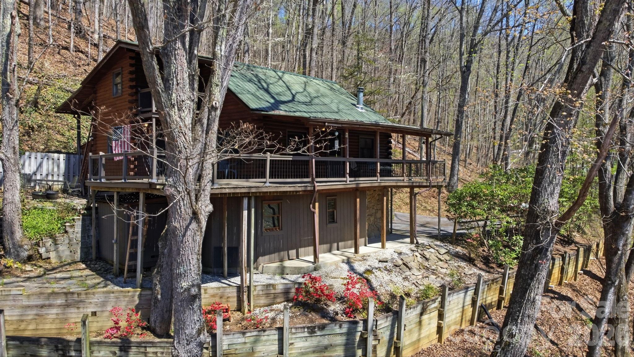 1837 East Alarka Road Bryson City, NC 28713 - Photo 2 of 39 front view of a house with a tree