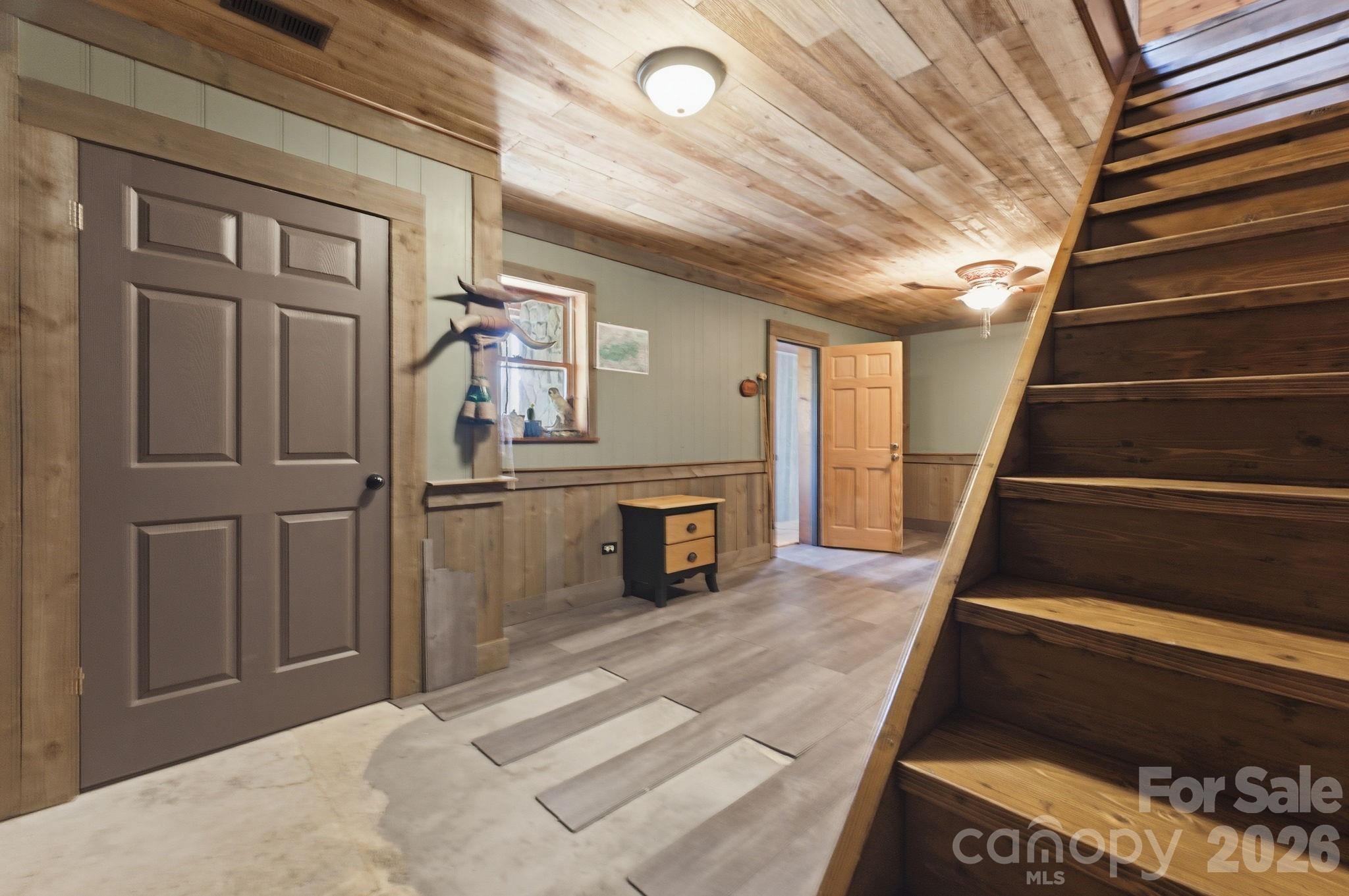 1837 East Alarka Road Bryson City, NC 28713 - Photo 24 of 34 a view of a livingroom with wooden floor and stairs