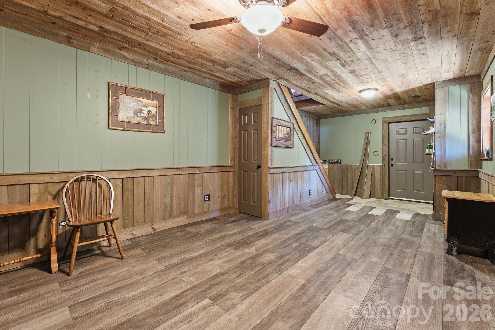 1837 East Alarka Road Bryson City, NC 28713 - Photo 25 of 34 a view of a hallway with wooden floor and staircase
