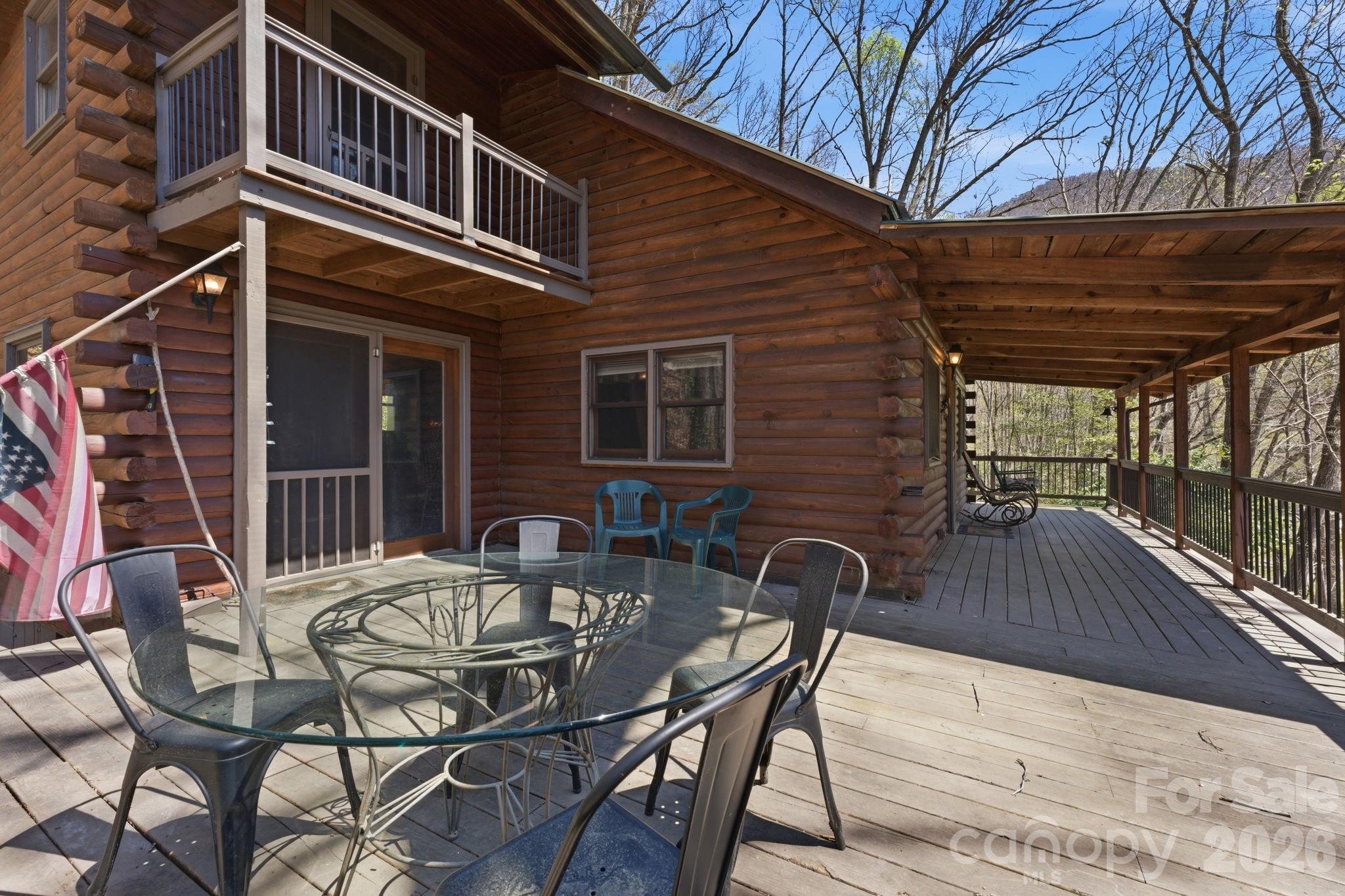 1837 East Alarka Road Bryson City, NC 28713 - Photo 3 of 34 a view of a patio with table and chairs with wooden floor and fence