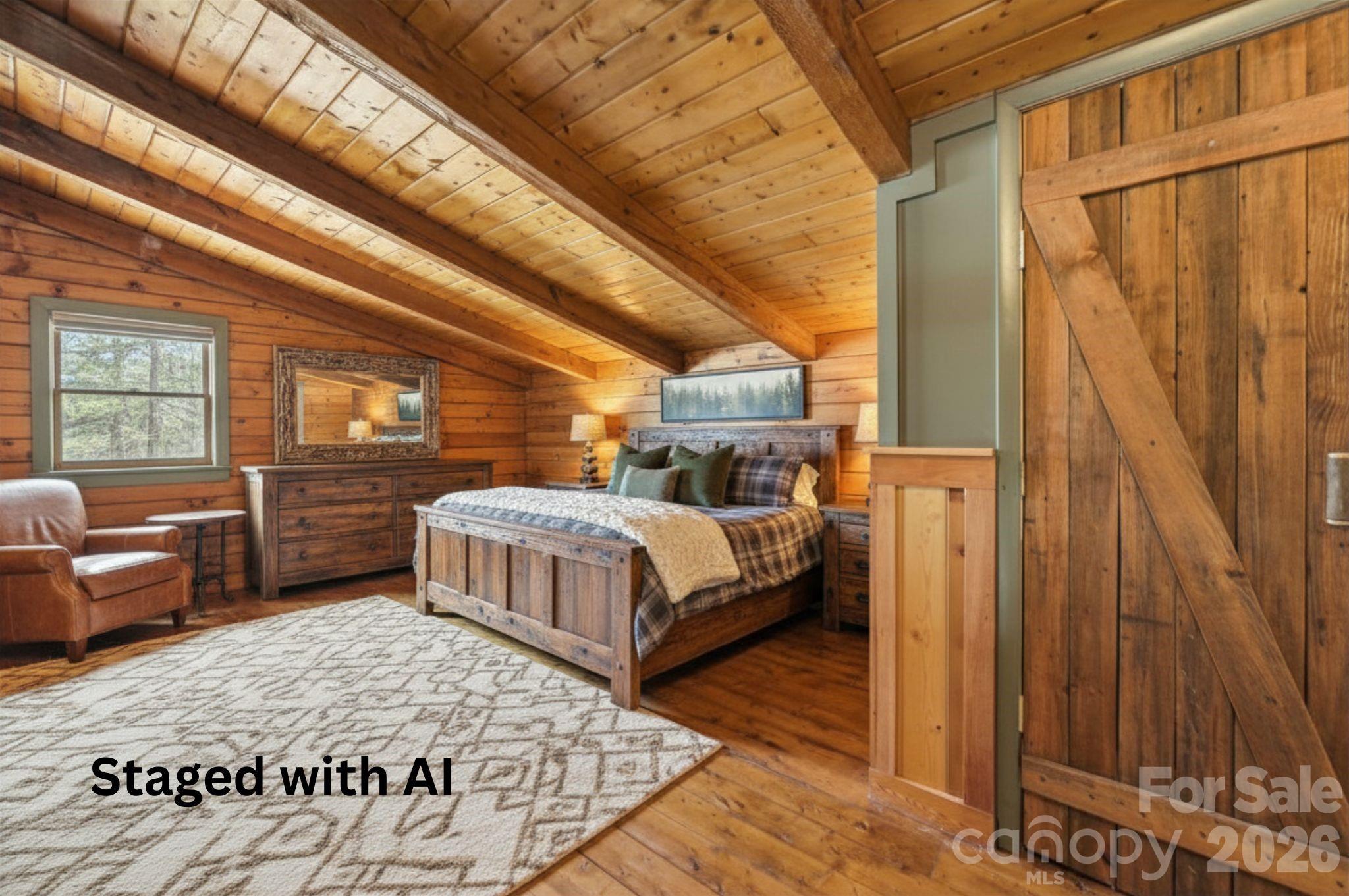 1837 East Alarka Road Bryson City, NC 28713 - Photo 8 of 39 a spacious bedroom with a bed a couch and dresser