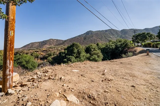 a view of a road with a house in the background