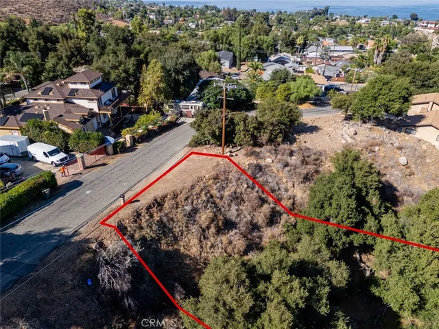 an aerial view of residential house and sandy dunes