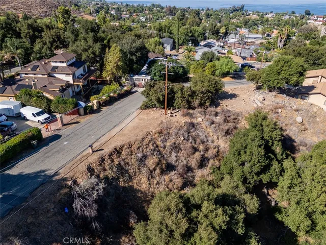 a view of a lush green field with mountains in the background