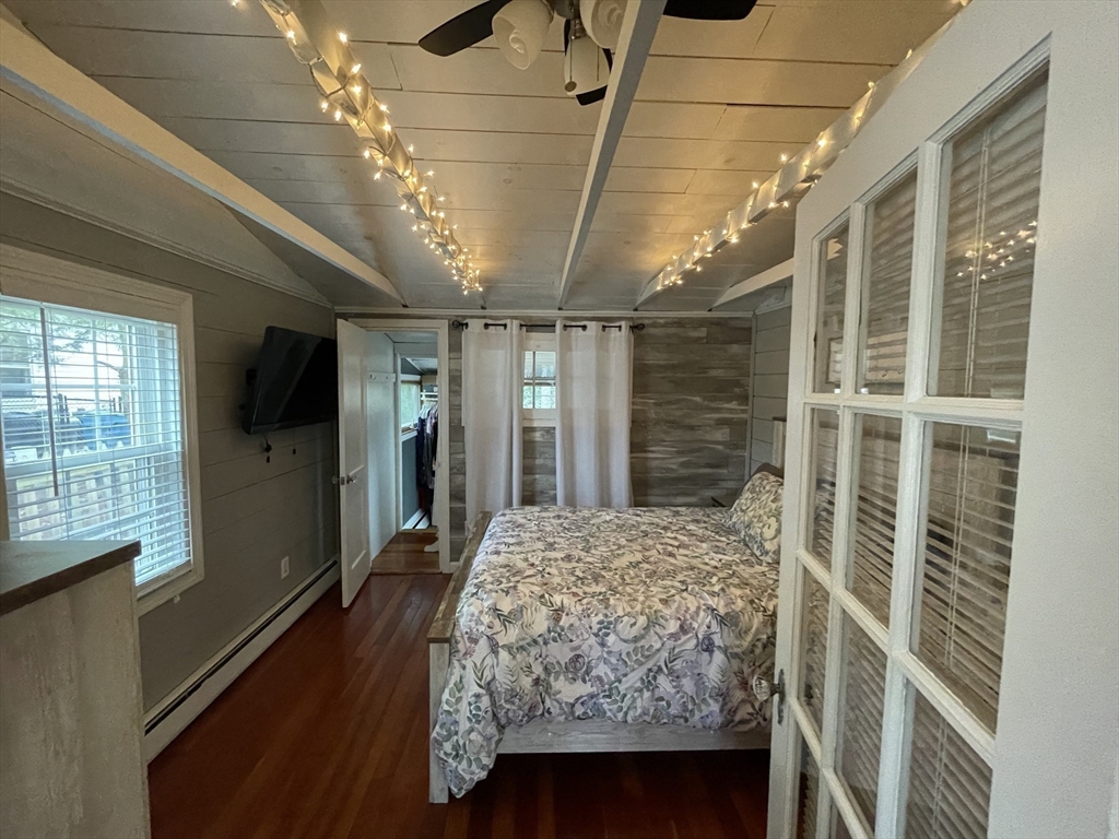 95 Pleasant Circle Canton, MA 02021 - Photo 12 of 17 a bedroom with a bed closet and a flat tv screen