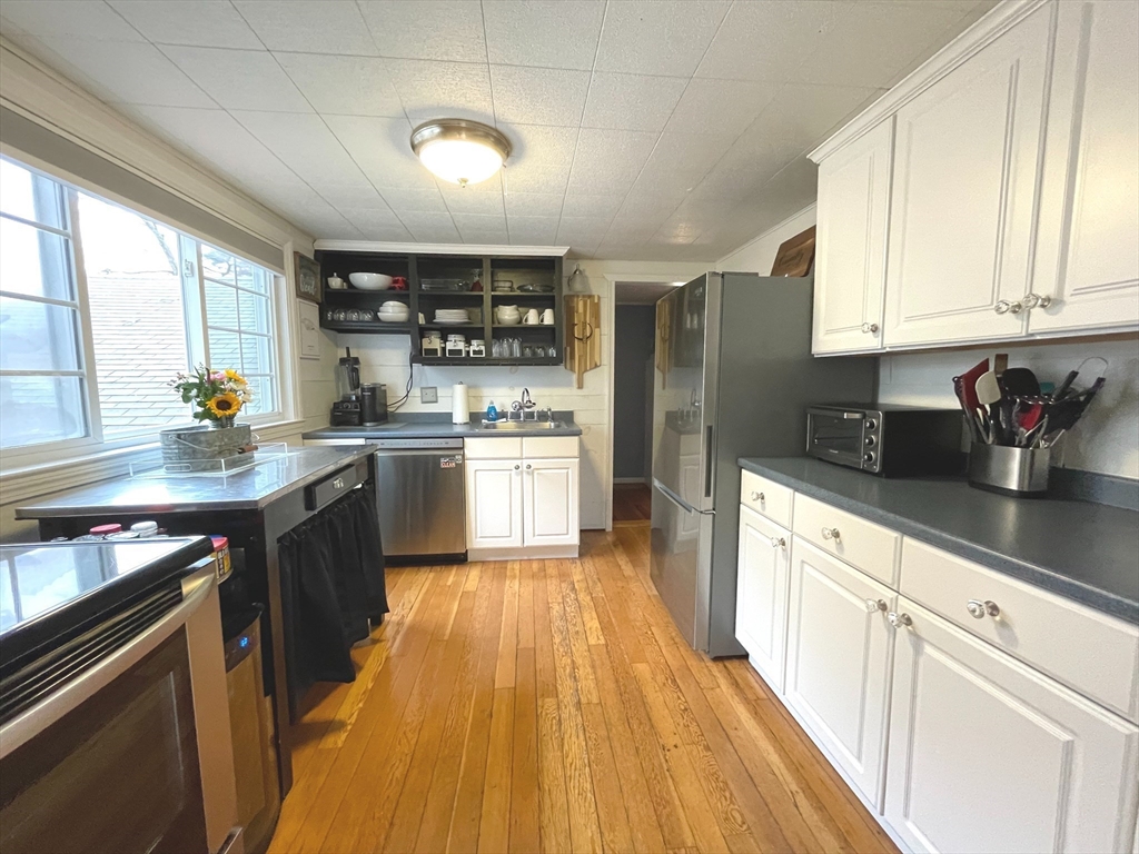 95 Pleasant Circle Canton, MA 02021 - Photo 9 of 17 a kitchen with stainless steel appliances granite countertop a sink stove and refrigerator