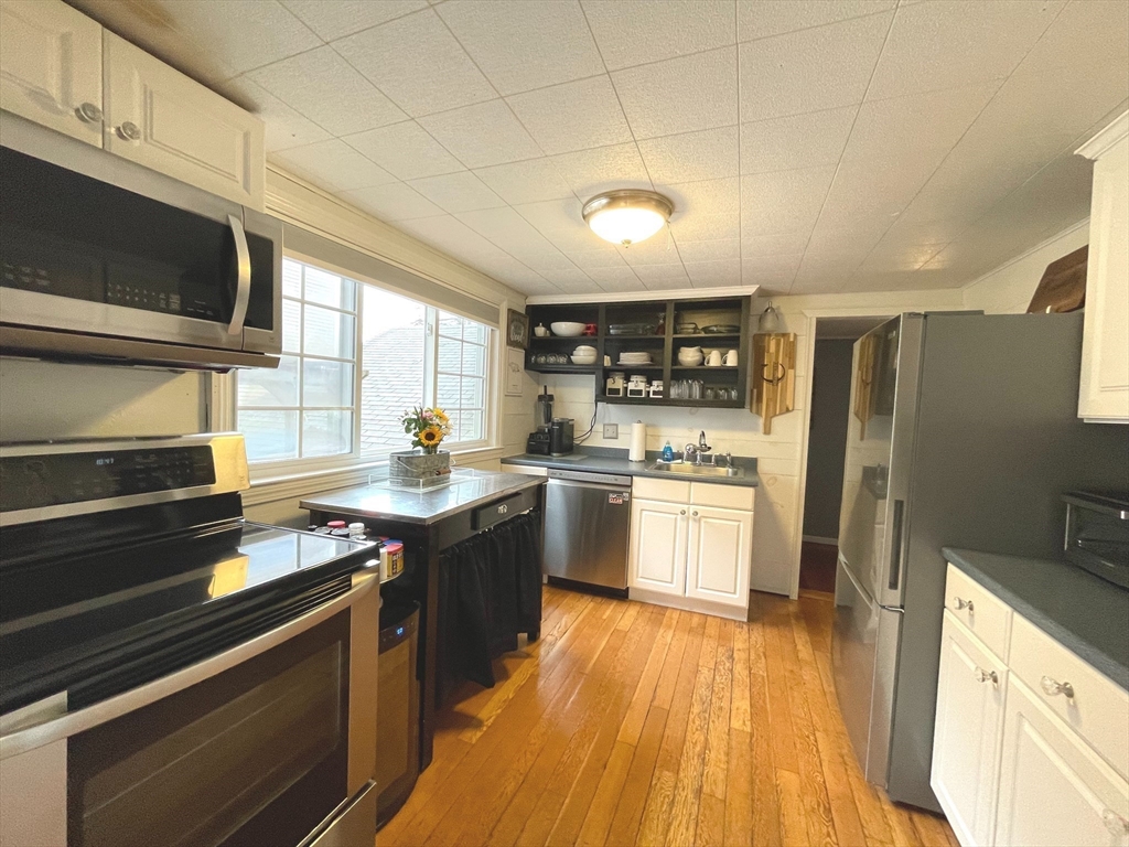 95 Pleasant Circle Canton, MA 02021 - Photo 10 of 17 a kitchen with granite countertop stainless steel appliances and wooden cabinets