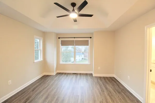 wooden floor in an empty room with a window