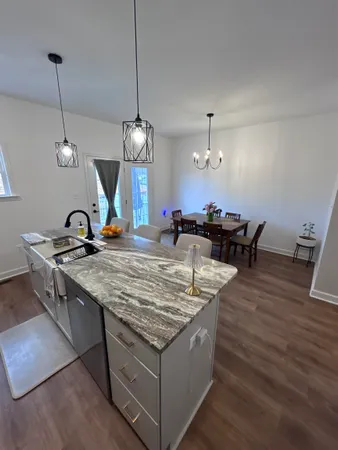 a living room with dining table and chairs