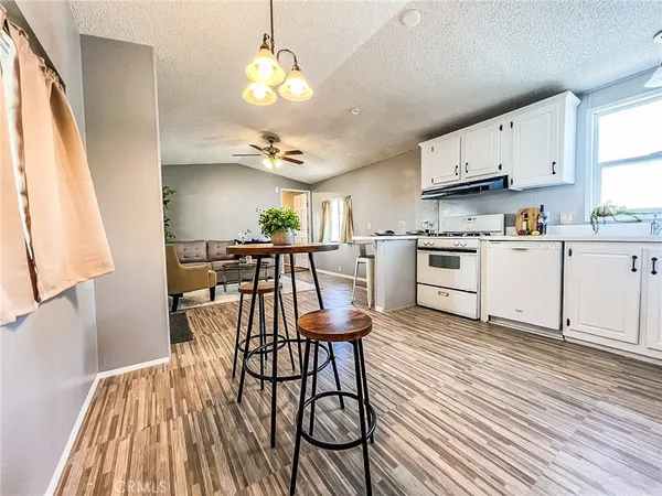 a view of kitchen with cabinets and wooden floor