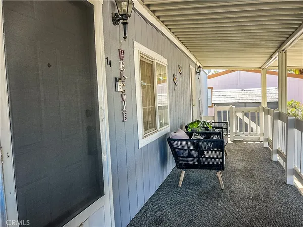 a view of two chairs in the balcony