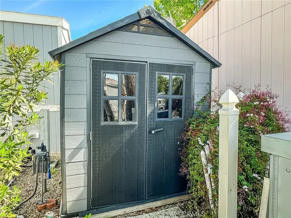a view of a house with potted plants