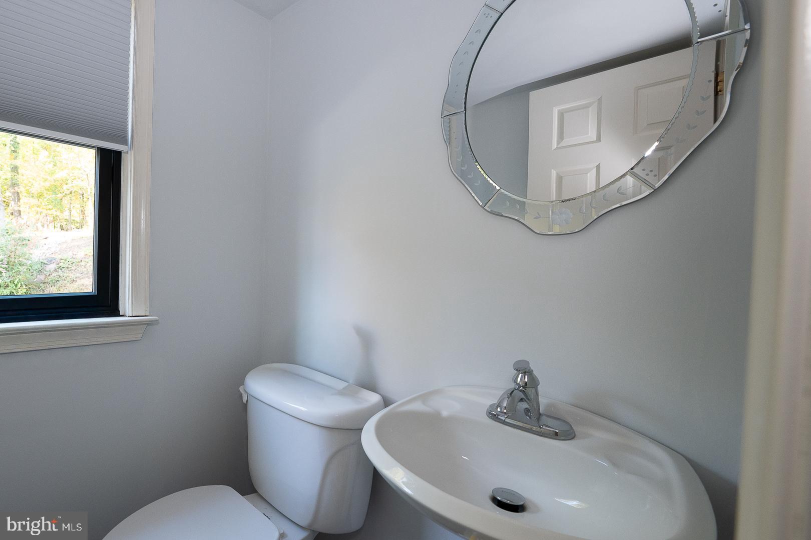 800 Maple Glen Lane Wayne, PA 19087 - Photo 26 of 52 a bathroom with a sink mirror and toilet