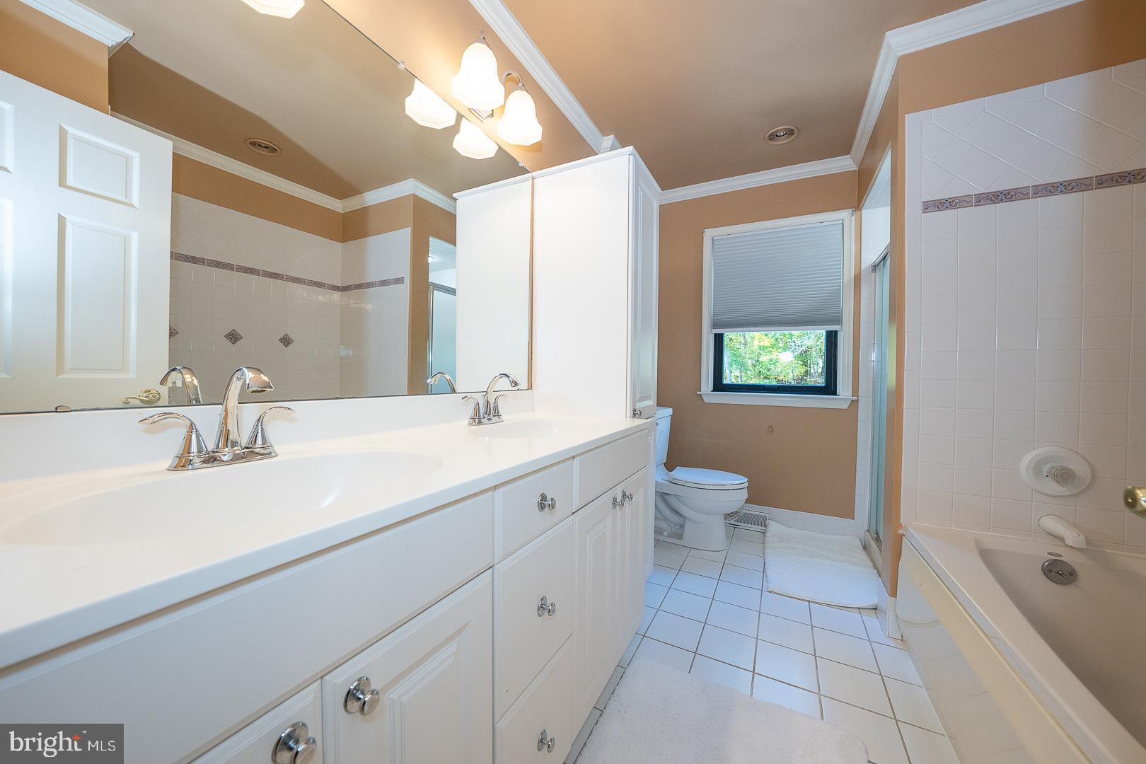 800 Maple Glen Lane Wayne, PA 19087 - Photo 35 of 52 a spacious bathroom with a double vanity sink toilet mirror and shower