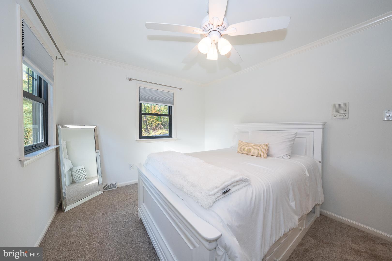 800 Maple Glen Lane Wayne, PA 19087 - Photo 38 of 52 a bedroom with a bed and a chandelier