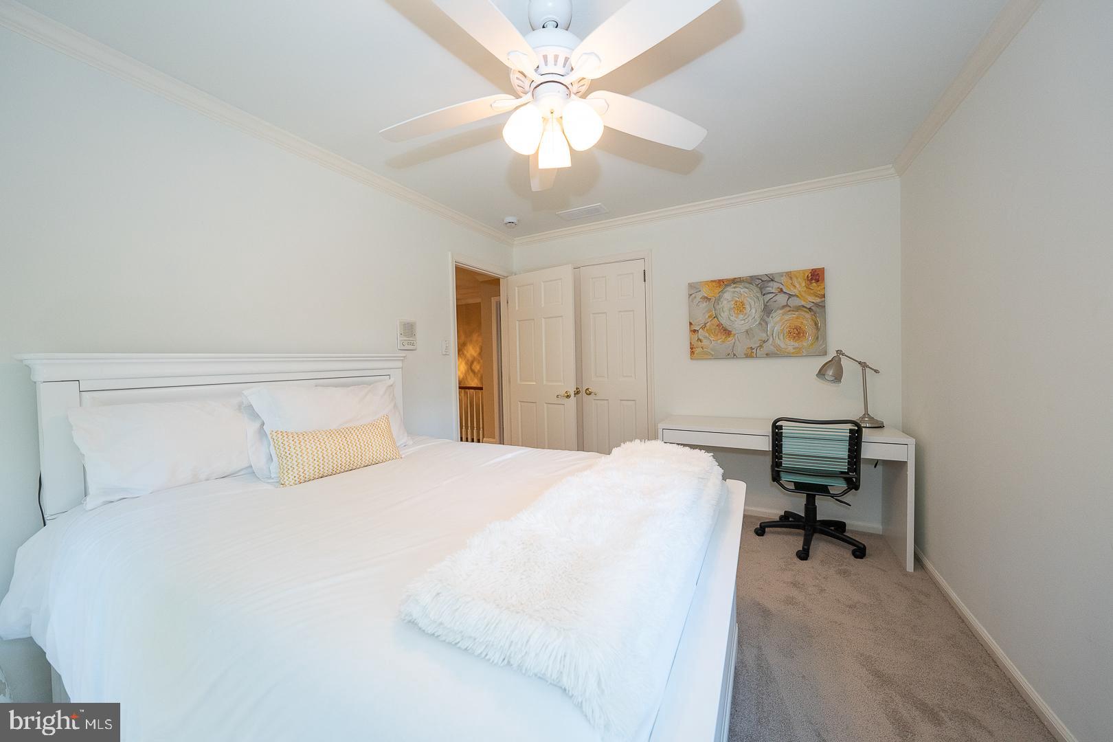 800 Maple Glen Lane Wayne, PA 19087 - Photo 39 of 52 a bedroom with a bed and a chandelier