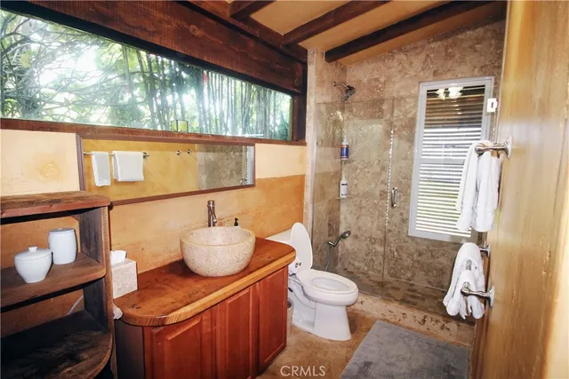a bathroom with a sink toilet and shower