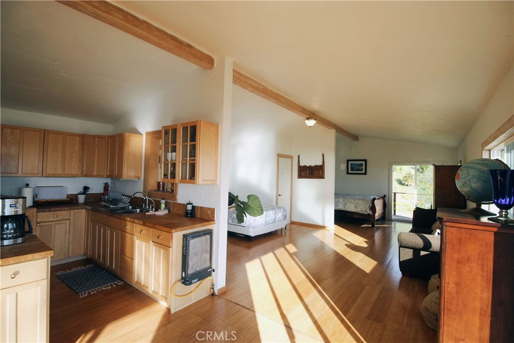 0 Morning Glory Ranch Big Sur, CA 93920 - Photo 21 of 35 a kitchen with a sink a counter top space a living room and dining room view