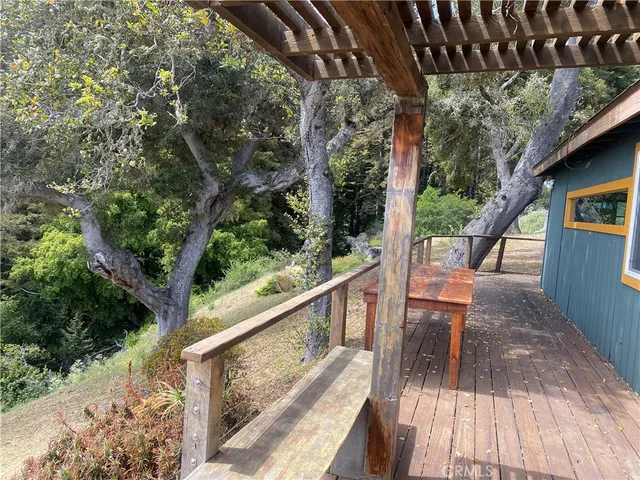 a view of balcony with wooden floor and outdoor seating
