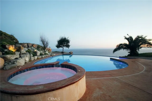 a view of a swimming pool with seating