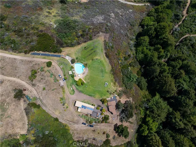 an aerial view of a house with a yard