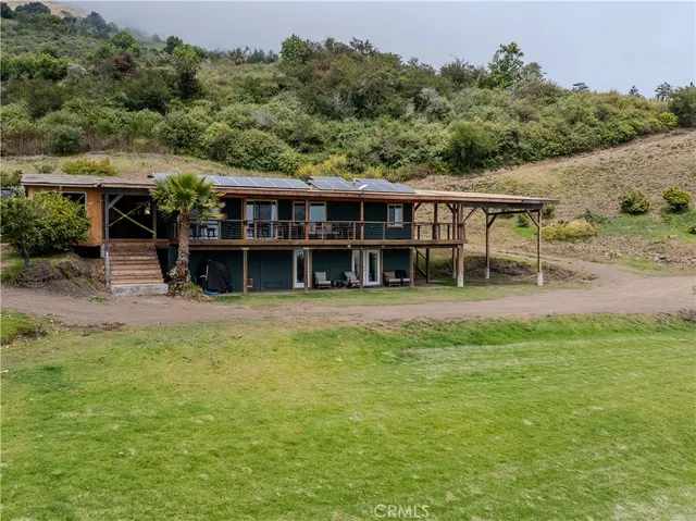 an outdoor view of house with swimming pool and green space