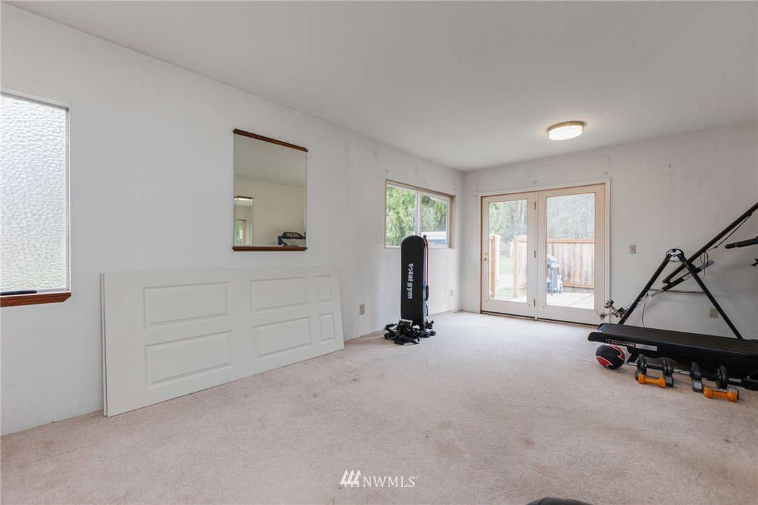 15408 Southeast Jones Road Renton, WA 98058 - Photo 17 of 40 a room with gym equipment and a large window