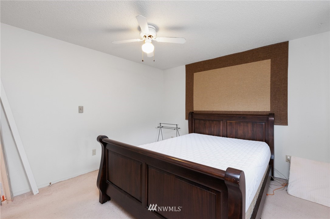 15408 Southeast Jones Road Renton, WA 98058 - Photo 19 of 40 a room with a bed and a chandelier