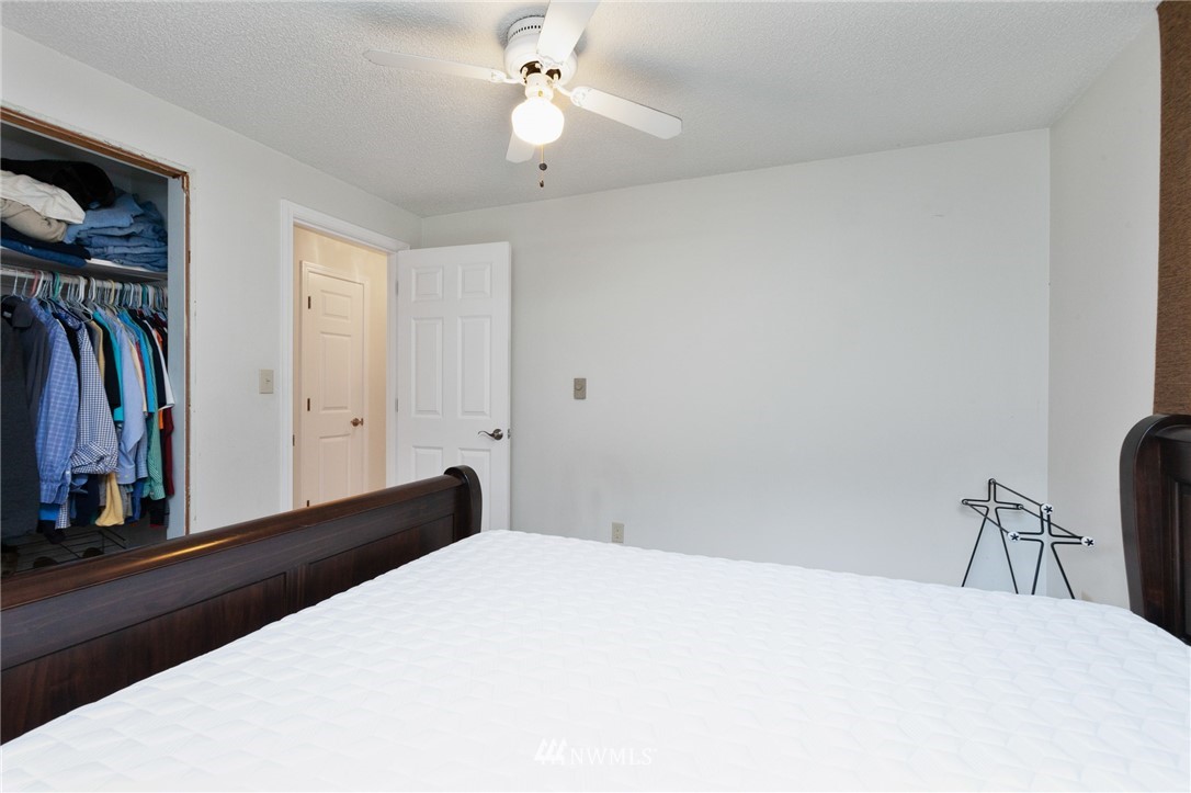 15408 Southeast Jones Road Renton, WA 98058 - Photo 20 of 40 a bedroom with a bed and a chandelier