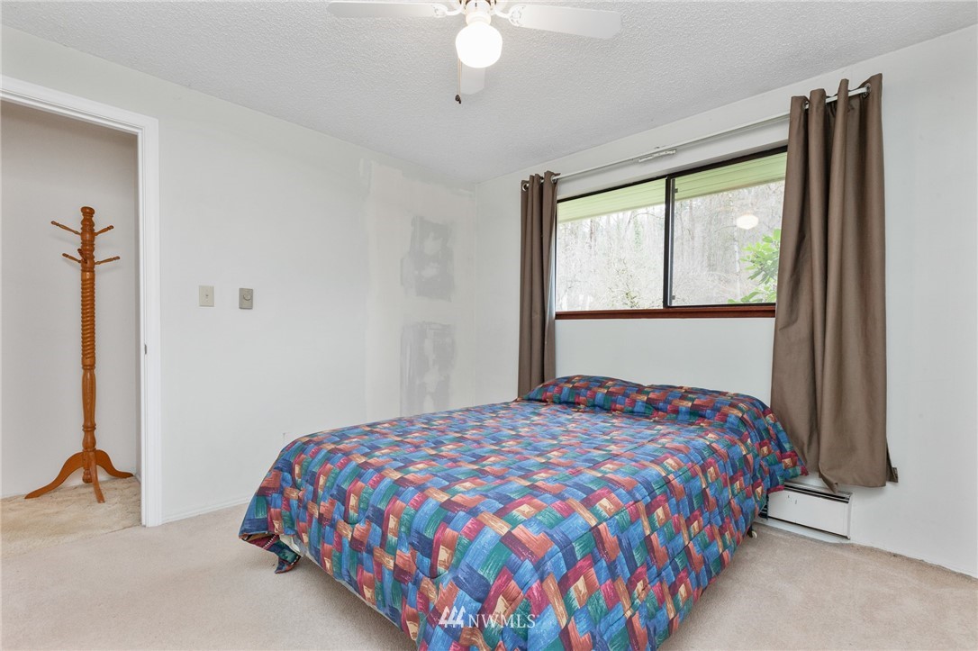 15408 Southeast Jones Road Renton, WA 98058 - Photo 27 of 40 a bedroom with a bed and a large window