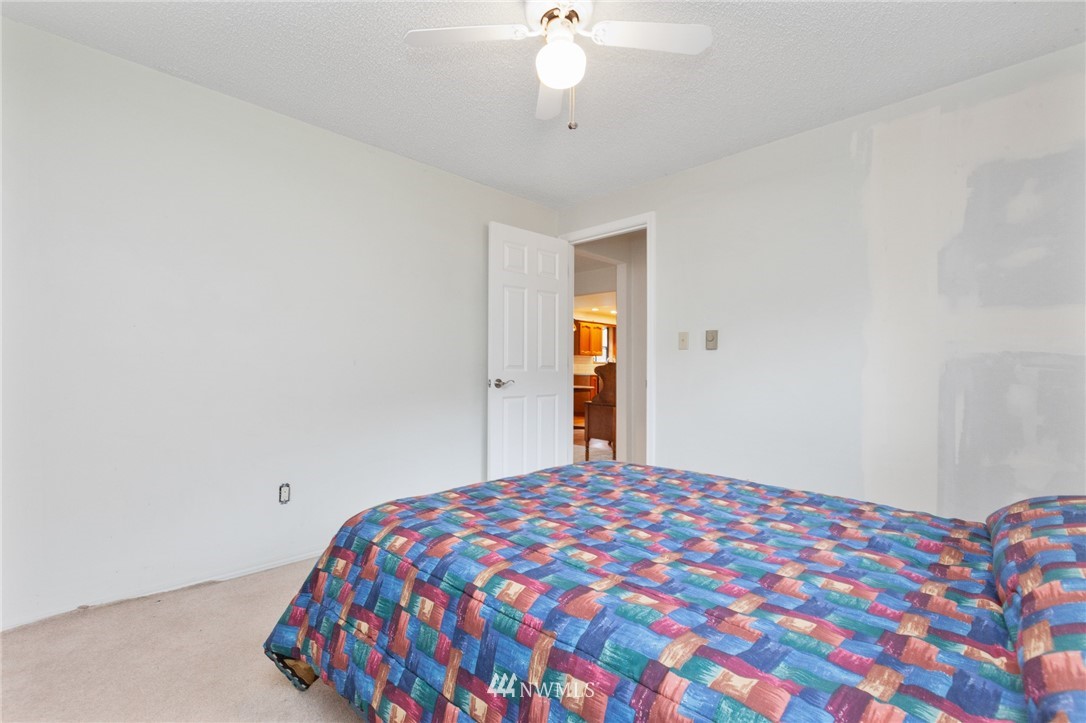 15408 Southeast Jones Road Renton, WA 98058 - Photo 28 of 40 a bedroom with a bed and a chandelier