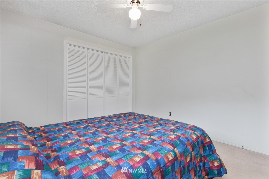 15408 Southeast Jones Road Renton, WA 98058 - Photo 29 of 40 a bedroom with a bed and a lamp