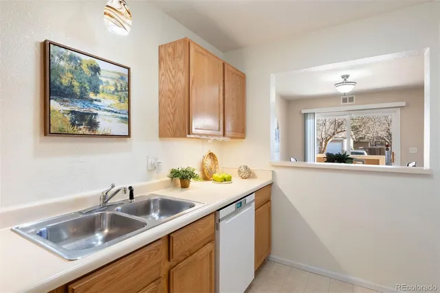 a kitchen with a sink cabinets and window