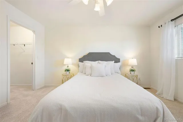 a bed room with a bed and a night stand