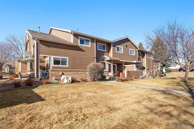 a view of a house with a yard covered in snow