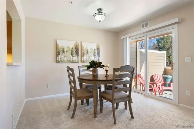 a view of a dining room with furniture and a window