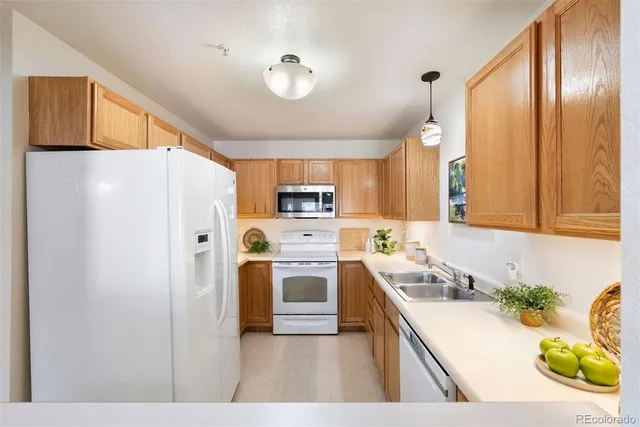 a kitchen with stainless steel appliances a refrigerator sink and stove