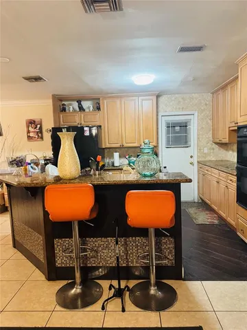 a room with table chairs and wooden floor