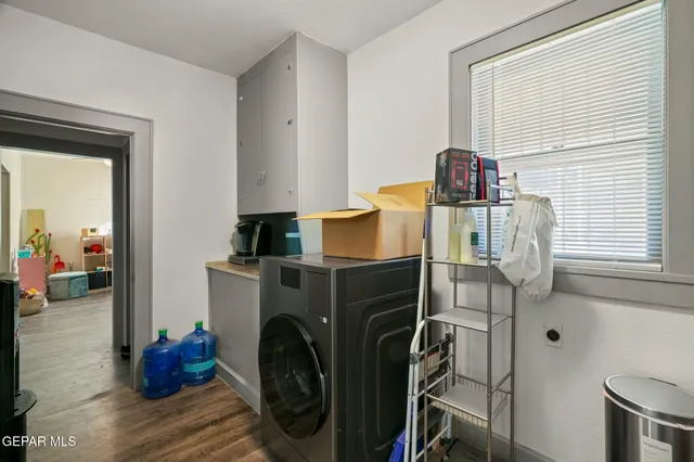 a kitchen with a sink a refrigerator and cabinets