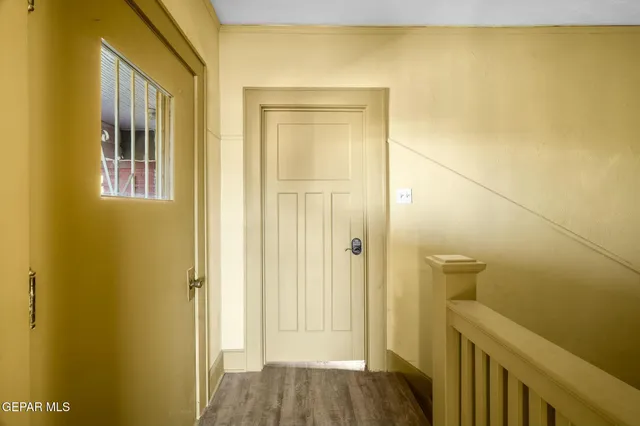 a view of a hallway with wooden floor