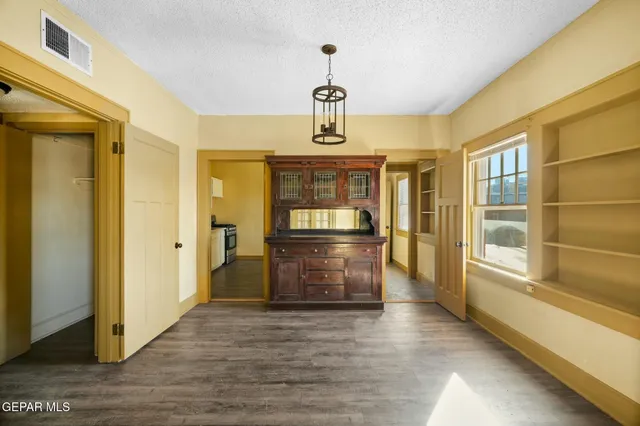 a view of room with wooden floor and ceiling fan