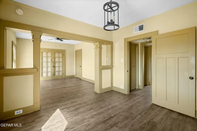 a view of a big room with wooden floor and windows