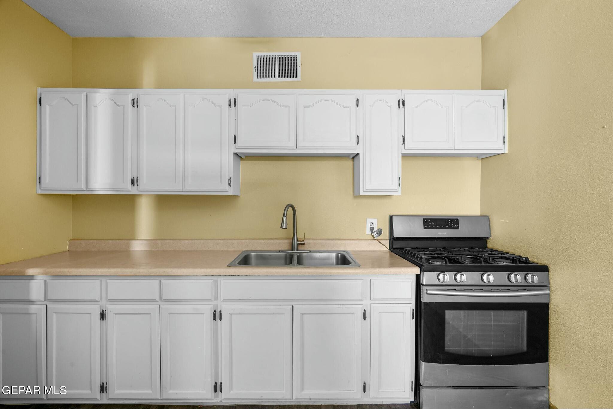500 Fewel Street, Unit A & B El Paso, TX 79902 - Photo 41 of 61 a kitchen with white cabinets and appliances