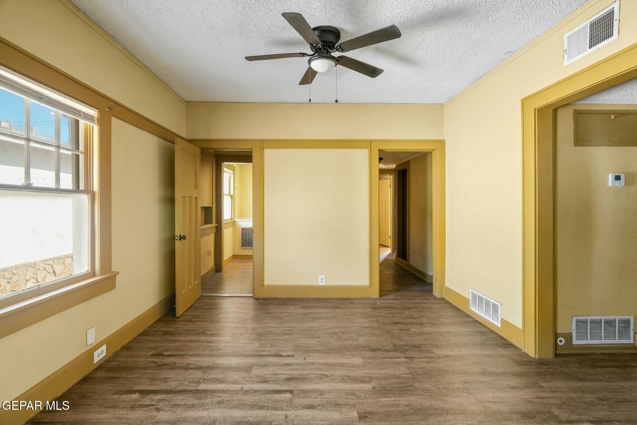 500 Fewel Street, Unit A & B El Paso, TX 79902 - Photo 50 of 61 a view of a hallway with wooden floor and a ceiling fan