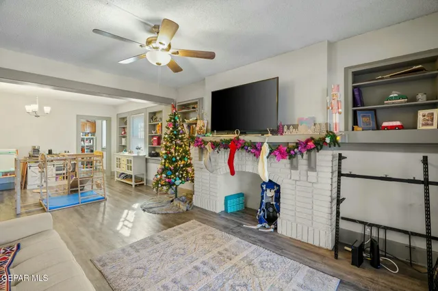 a living room with furniture a rug and a chandelier