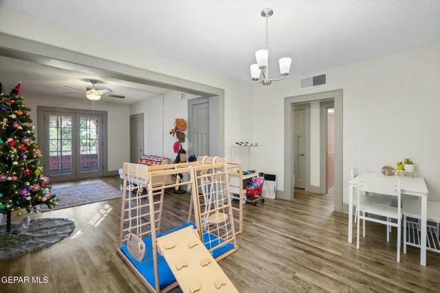 a view of a livingroom with dining room and wooden floor